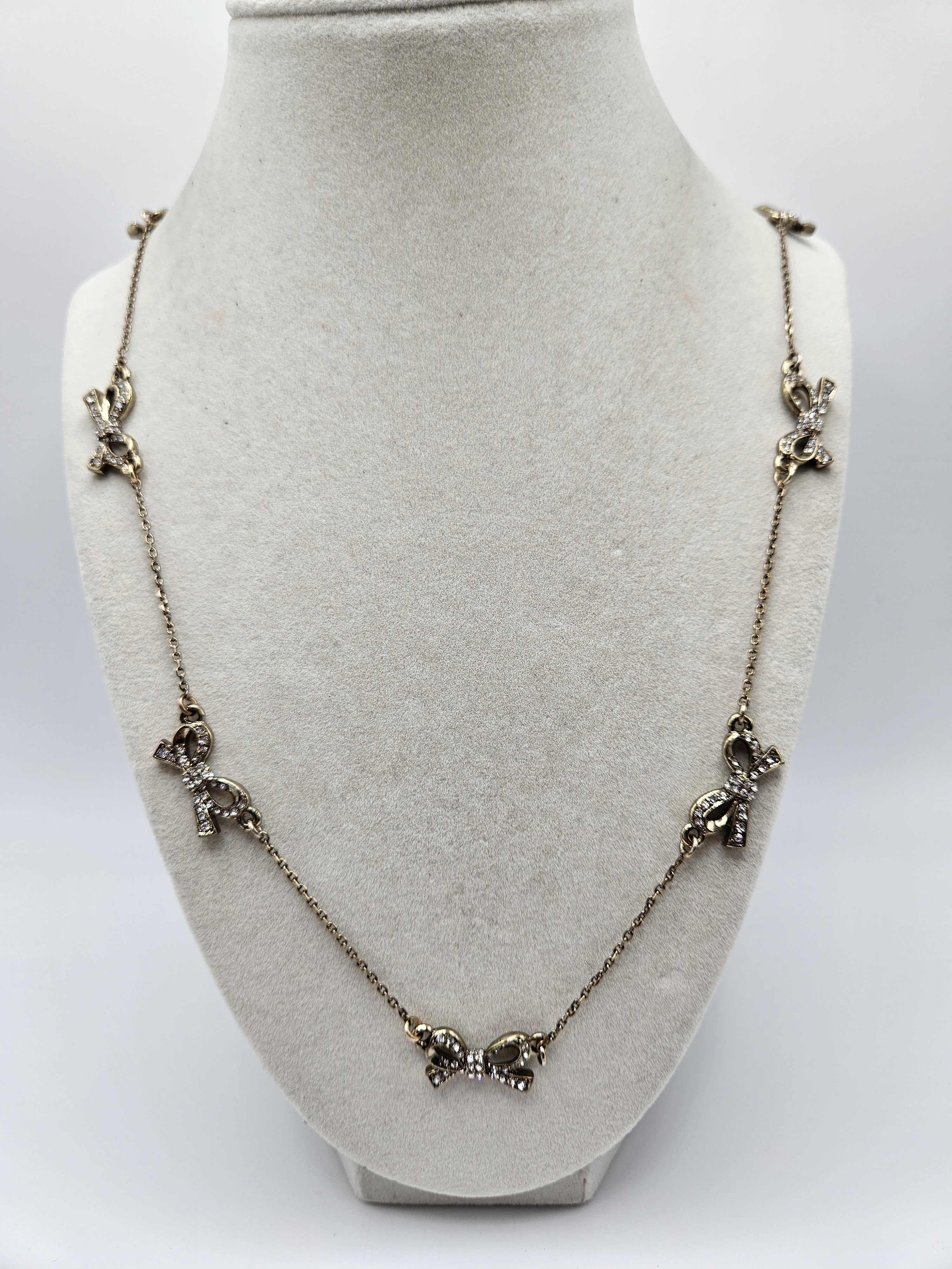 Bella Jack Gold Tone Rhinestone Bow Station Charm Strand Necklace